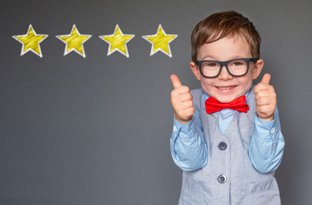 Reviews. Cute little boy giving thumbs up with 4 stars approved
